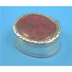 A George IV Irish silver snuff box of oval form with red marble inset lid, 2 ins. Maker Henry Fla...