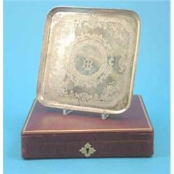 A Victorian square form silver salver with bright cut foliate engraving, Makers Martin Hall & Co....