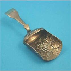 A George III silver gilt caddy spoon of shovel form with vineous decoration, Birmingham 1813....