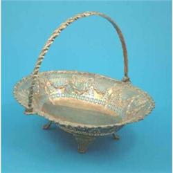An Elkington's plated bread basket of oval form with swing handle....