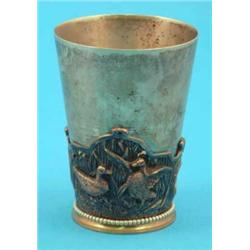 A Victorian plated tumbler cup, decorated in relief with game birds....