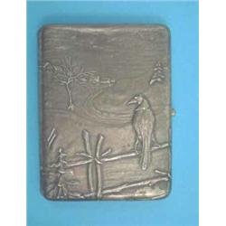 A Russian 84 zolotnik cigarette case decorated in relief with a crow on a fence in a winter lands...