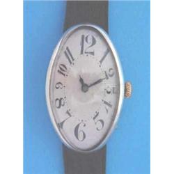 A gentleman's silver Art Deco wrist watch of curved oval form with silvered Arabic dial and blued...