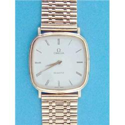 A gentleman's 9ct. gold Omega quartz wrist watch with rounded square dial and flexible bracelet....