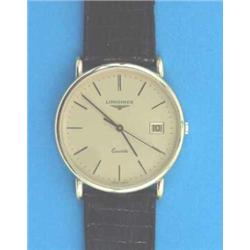 A gentlemans 9ct gold Longines wrist watch with quartz movement and date aperture....