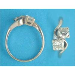 An 18ct white gold 2-stone diamond cross over ring, the brilliant cut stones approximately .6ct e...
