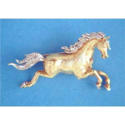 A 2-colour gold brooch, modelled as a galloping horse, the mane and tail set small diamonds....