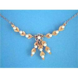 A modern gold and cultured pearl necklace, designed as pairs of leaves, on a 9ct gold trace link...