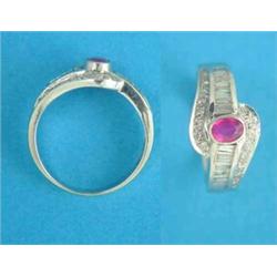 A 14ct white gold ring, collet set with an oval ruby and bands of baguette and round cut diamonds...