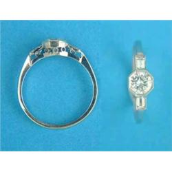 An 18ct white gold solitaire diamond ring, the shoulders set baguette cut diamonds...