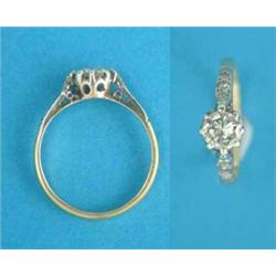 An 18ct gold solitaire diamond ring, the shoulders set small diamonds...