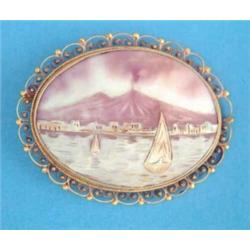 A shell cameo brooch, carved with a study of the Bay of Naples and Mount Vesuvius, in gold wirewo...
