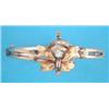 Image 1 : A gold hinged bangle, the tied ribbon front set with a clear paste and seed pearls...