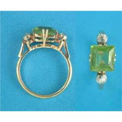 An 18ct gold ring, claw-set with a square cut peridot, each shoulder set with a round cut diamond...