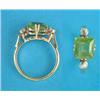 Image 1 : An 18ct gold ring, claw-set with a square cut peridot, each shoulder set with a round cut diamond...