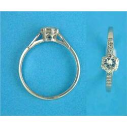 A platinum solitaire diamond ring, with diamond set shoulders, the brilliant cut stone approximat...