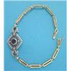 Image 1 : A gold flexible bracelet, the lozenge shape openwork front set with a sapphire and rose cut diamo...