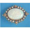 Image 1 : A 15ct gold brooch, set with an oval opal framed by split pearls and demantoid garnets...
