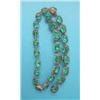 Image 1 : A gilt metal and green paste riviere necklace, closed back setting...