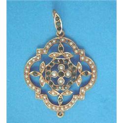 An Edwardian gold quatrefoil shape openwork pendant, set seed pearls and emeralds...