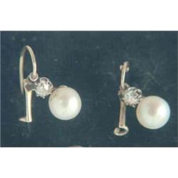 A pair of Victorian drop earrings, each set with a single pearl on an old brilliant cut diamond s...