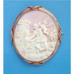 A Victorian shell cameo oval brooch, carved figures, dogs and a cherub, in a gold frame, 2.25ins...
