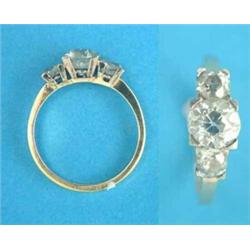 An 18ct gold 3-stone diamond ring, the old brilliant cut central stone, approximately 1ct...