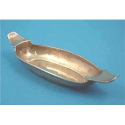 A Liberty & Co hammered silver trinket dish of oval form with lug handles, Birmingham 1911, 5.75...