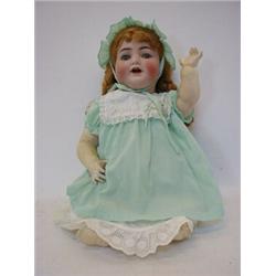 A SIMON & HALBIG BISQUE HEAD DOLL, Titian wigs, sleeping eyes, open mouth, jointed limbs, polkado...