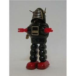 A PLANET ROBOT, 1960's, by Horikawa, Japan, black body, clockwork action, height 23cm  50-80...
