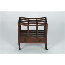 A LATE GEORGE III MAHOGANY CANTERBURY, fitted drawer to the base with turned pulls, on turned sup...