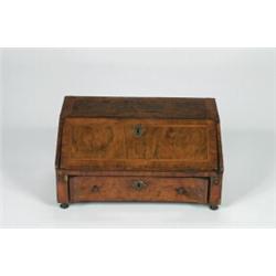 AN EARLY 18TH CENTURY WALNUT TABLE TOP DESK, crossbanded, and with drop flat enclosing a well fit...