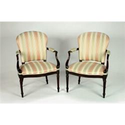 A PAIR OF GEORGE III MAHOGANY OPEN ARMCHAIRS, in the Hepplewhite manner, with padded backs, seats...