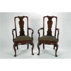 A SET OF EIGHT WALNUT DINING CHAIRS, in the Queen Anne manner, with solid vase shaped back splats...