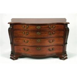 A FINE EARLY GEORGE III MAHOGANY SERPENTINE COMMODE, the shaped top above four graduated drawers...