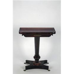 A SMALL REGENCY ROSEWOOD FOLD-OVER GAMES TABLE, on tapering cylindrical and knopped pedestal to s...