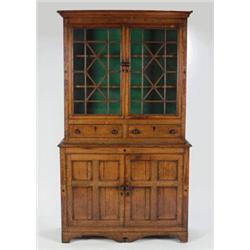 AN EARLY 19TH CENTURY OAK CABINET, the upper section fitted double astragally glazed doors enclos...