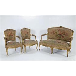 A 19TH CENTURY CARVED GILTWOOD FRAMED PARLOUR SUITE, in the Louis XV manner, in vintage floral ta...