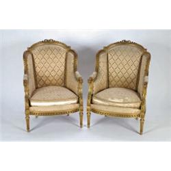 A PAIR OF ANTIQUE CARVED GILTWOOD FRAMED BERGERES, in the Louis XVI manner, upholstered in floral...