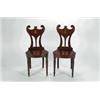 Image 1 : A SET OF FOUR GEORGE II MAHOGANY HALL CHAIRS, the shaped backs centred with an enamelled crest, w...