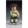 Image 1 : STAFFORDSHIRE TOBY JUG, the seated figure with green coat, ochre waistcoat and blue breeches hold...