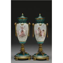 PAIR OF 'SEVRES' ORMOLU MOUNTED VASES AND COVERS, of ovoid form painted in colours with gilt bord...