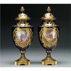 PAIR OF 'SEVRES' BLUE-GROUND COVERED URNS, with gilt brass mounts and gilt decoration, the ovoid...