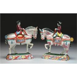 PAIR OF DUTCH DELFT FIGURES ON HORSEBACK, each with an eighteenth century suited gentleman in tri...