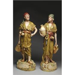 PAIR OF ROYAL DUX FIGURES OF EASTERN WATER CARRIERS, standing on landscaped bases, painted in col...