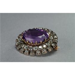 14K YELLOW GOLD AND SILVER BROOCH, centering an oval cut amethyst within 2 circles of 40 old cut...