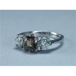 PLATINUM RING, set with an oval cut alexandrite (approx. 1.68ct.) flanked by 2 brilliant cut diam...