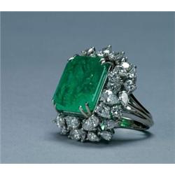 14K WHITE GOLD COCKTAIL RING, set with an emerald cut emerald (approx. 18.75ct.) within a frame o...