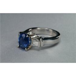 18K WHITE GOLD COCKTAIL RING, set with an oval cut sapphire (approx. 3.94ct) flanked by 6 channel...