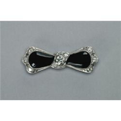 PLATINUM FILIGREE BOW BROOCH, set with 2 shaped onyx cabochons in a mount decorated with 13 vario...